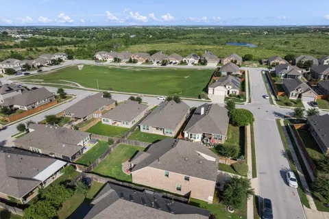 an aerial view of a house with a garden and mountain view in back