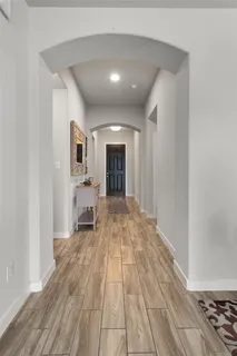 a big room with wooden floor and fireplace