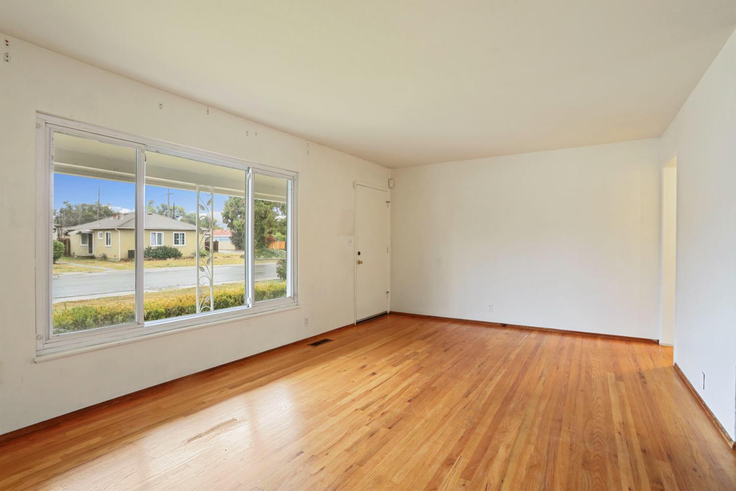 2755 Inman Avenue Stockton, CA 95204 - Photo 12 of 34 wooden floor in an empty room with a window
