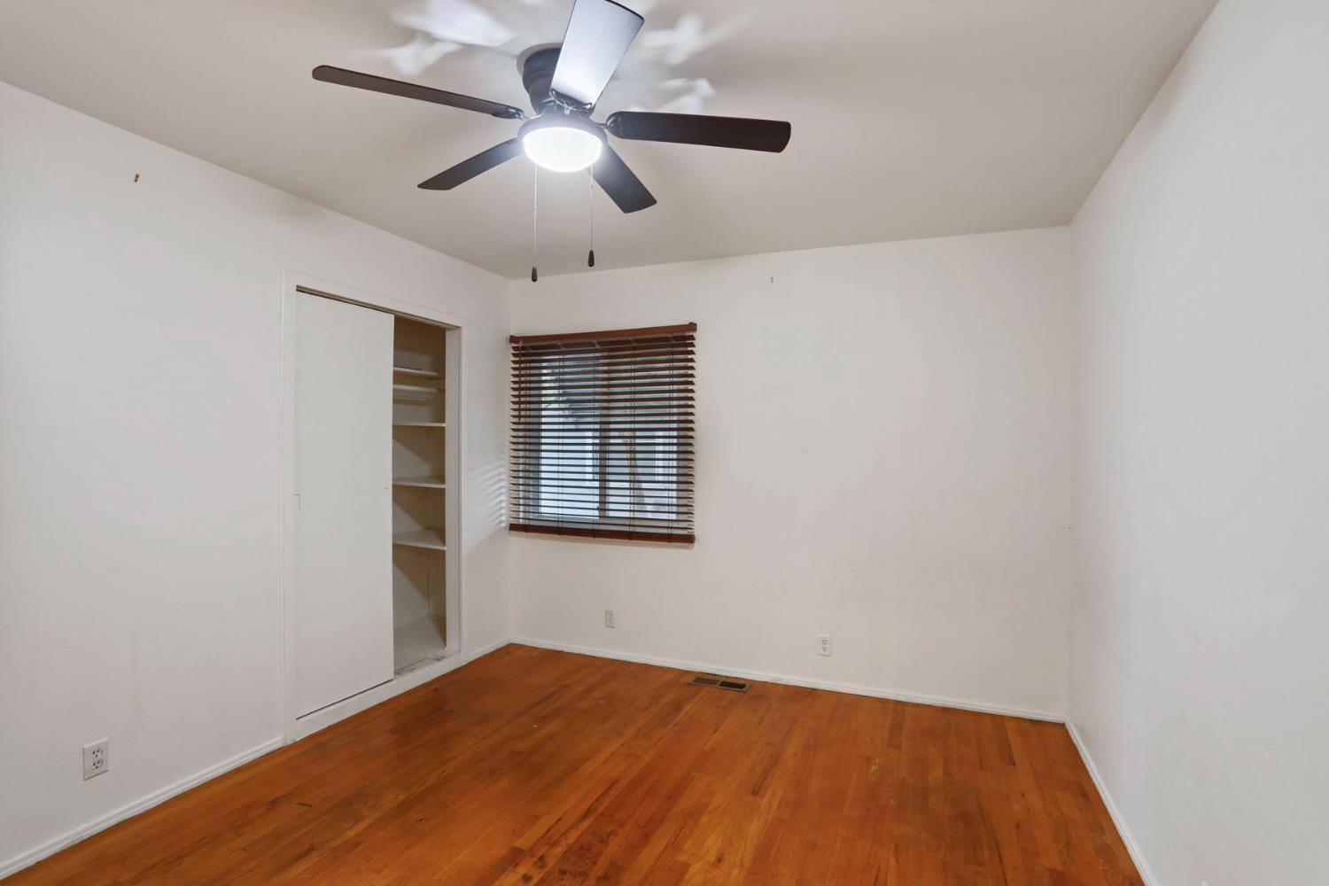 2755 Inman Avenue Stockton, CA 95204 - Photo 17 of 34 an empty room with a window and a ceiling fan