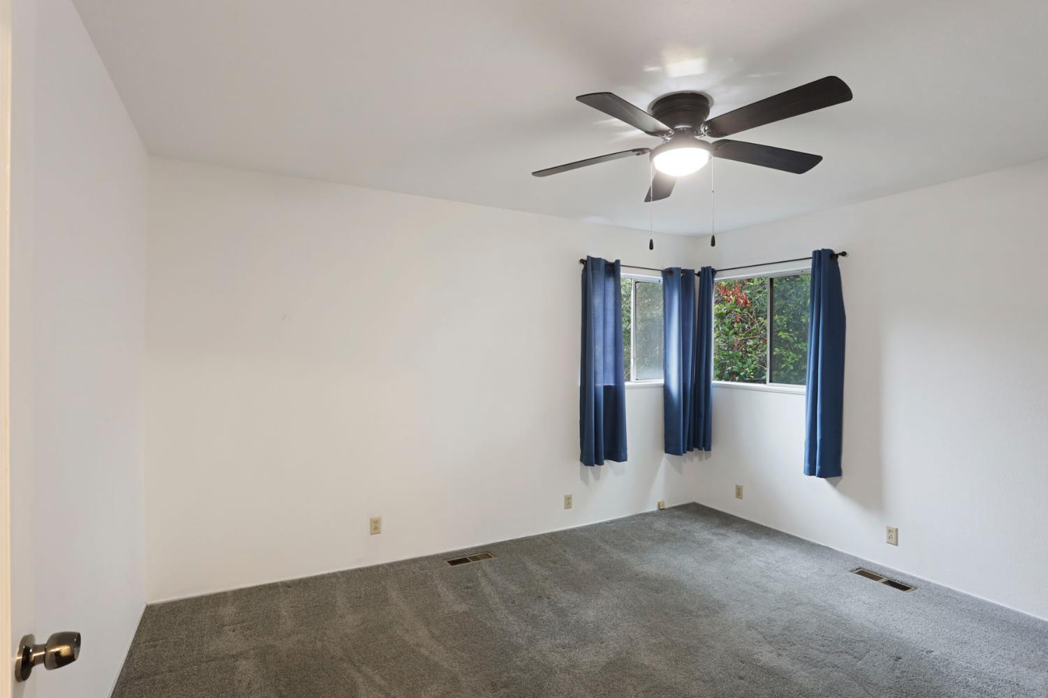 2755 Inman Avenue Stockton, CA 95204 - Photo 20 of 34 an empty room with a ceiling fan and window