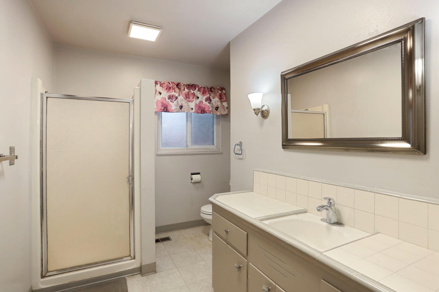 2755 Inman Avenue Stockton, CA 95204 - Photo 21 of 34 a bathroom with a sink vanity and mirror
