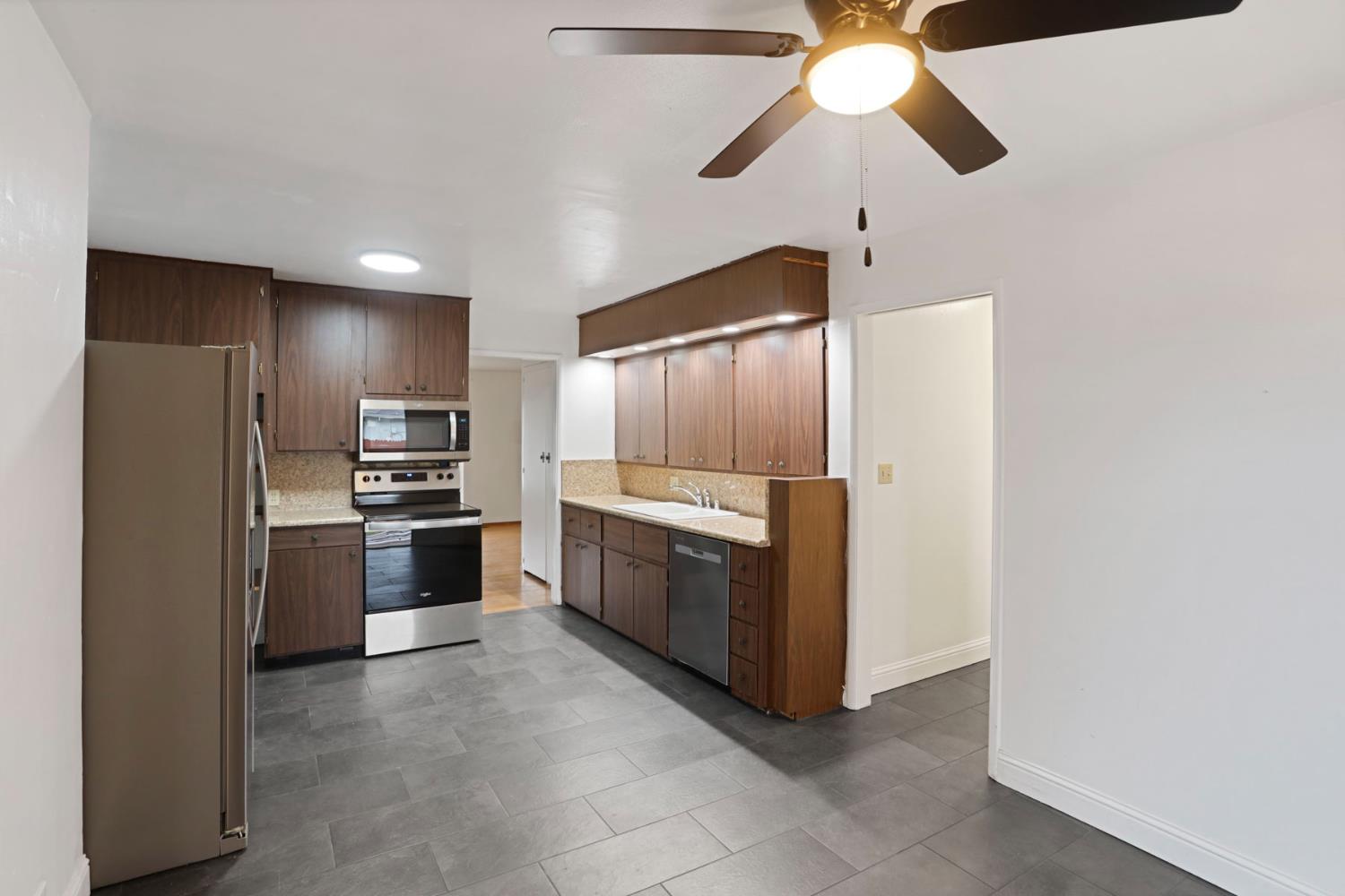 2755 Inman Avenue Stockton, CA 95204 - Photo 24 of 34 a large kitchen with cabinets and stainless steel appliances