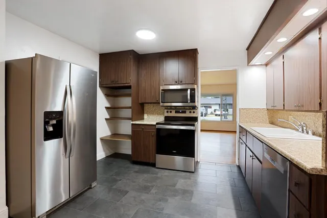 a view of an empty room with a fireplace