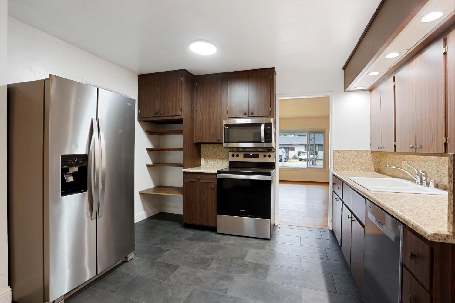 2755 Inman Avenue Stockton, CA 95204 - Photo 25 of 34 a kitchen with stainless steel appliances granite countertop a refrigerator stove and sink