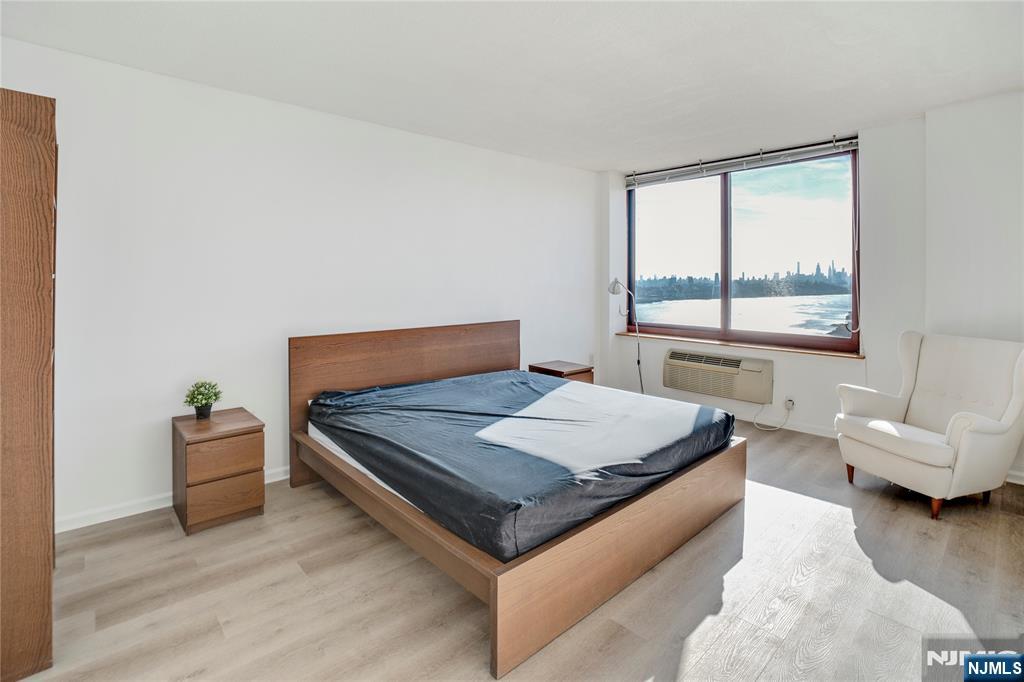 100 Old Palisade Road, Unit 2709 Fort Lee, NJ 07024 - Photo 14 of 15 a bedroom with a bed and wooden floor