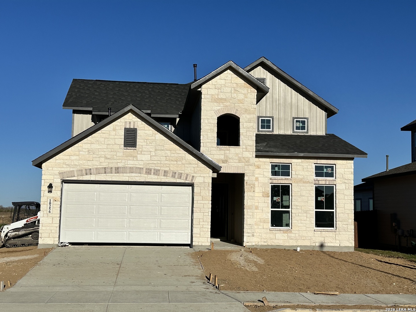 a front view of a house with a garage