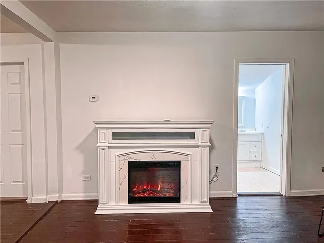 a kitchen with a white cabinets and wooden floor