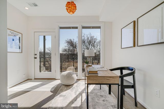 a living room with white furniture and a table
