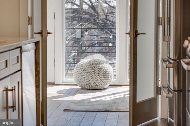 a view of a balcony with wooden floor and iron stairs