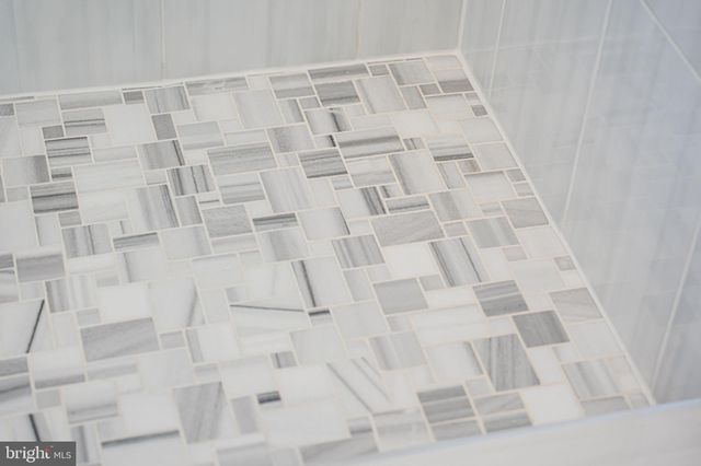 a kitchen with stainless steel appliances kitchen island granite countertop a dining table chairs microwave and sink