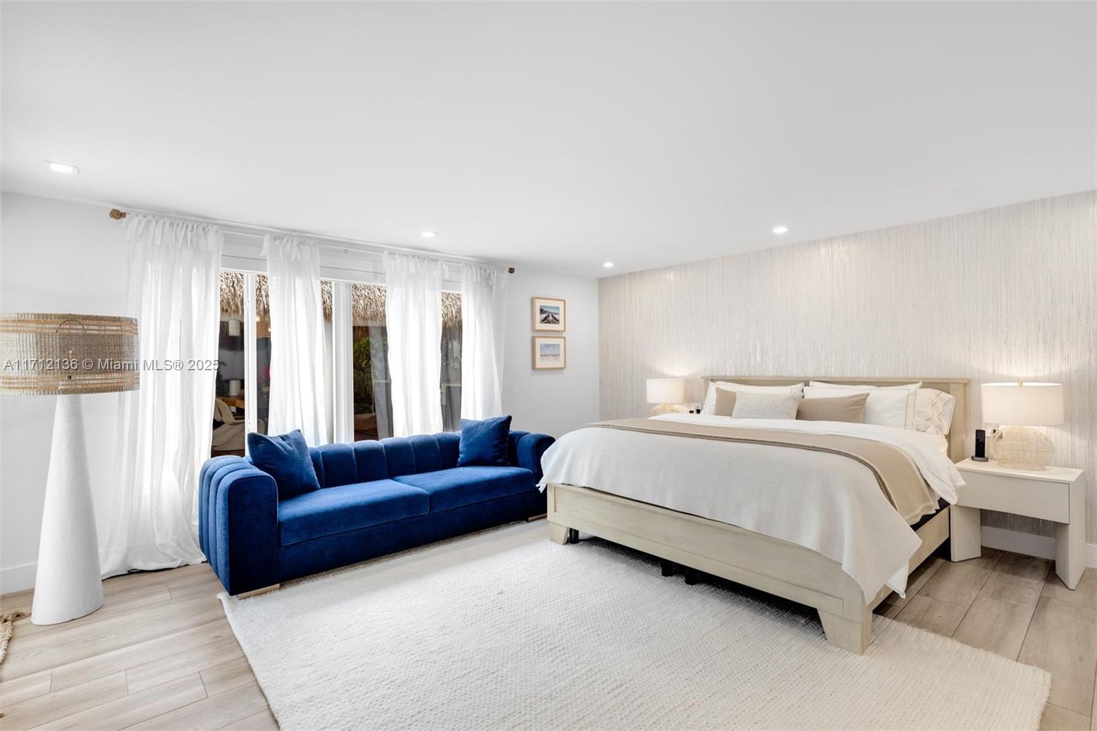 345 Gulf Road Key Biscayne, FL 33149 - Photo 16 of 43 a spacious bedroom with a bed couch and a window