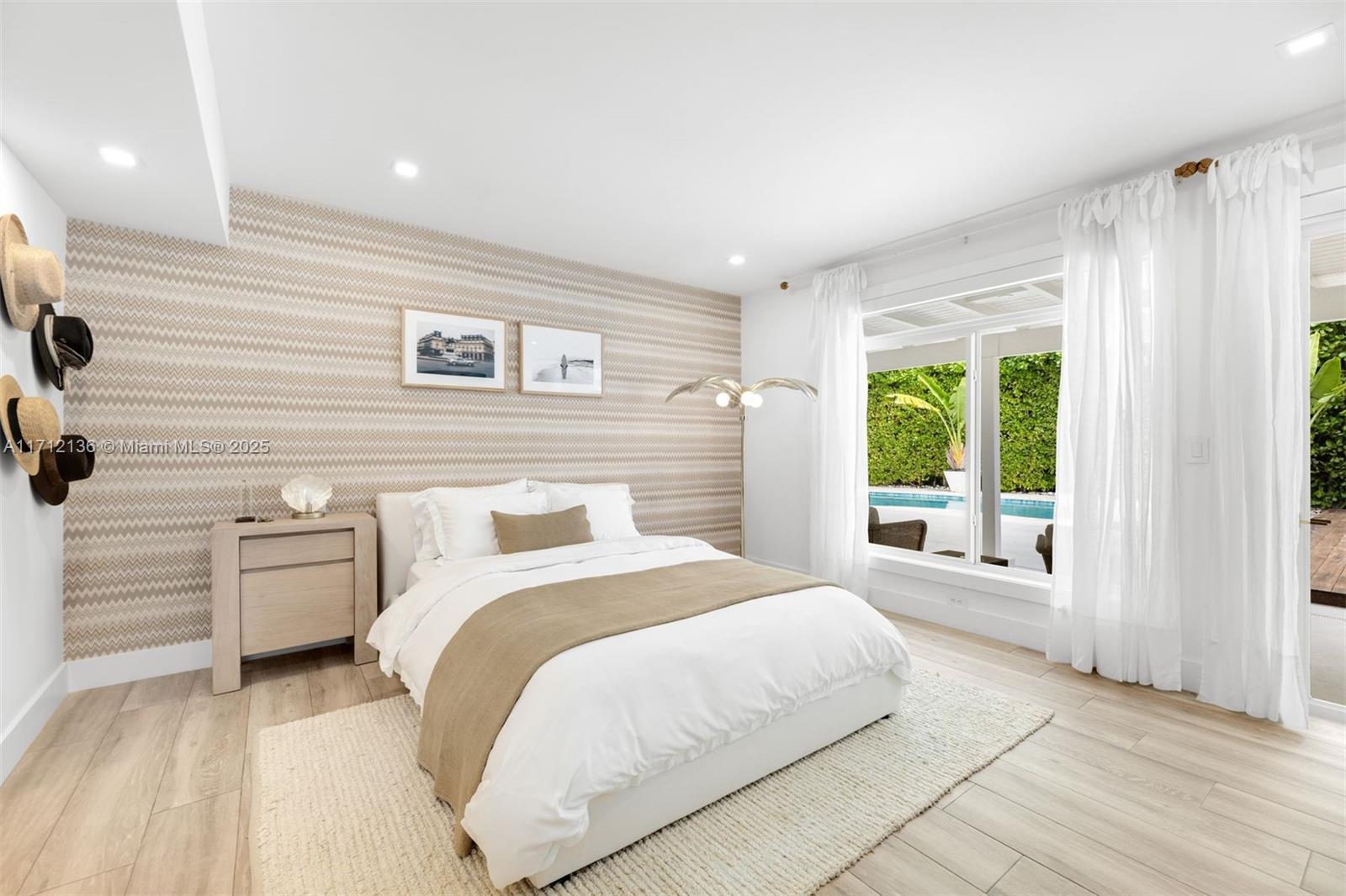 345 Gulf Road Key Biscayne, FL 33149 - Photo 21 of 43 a bedroom with a large bed and a large window