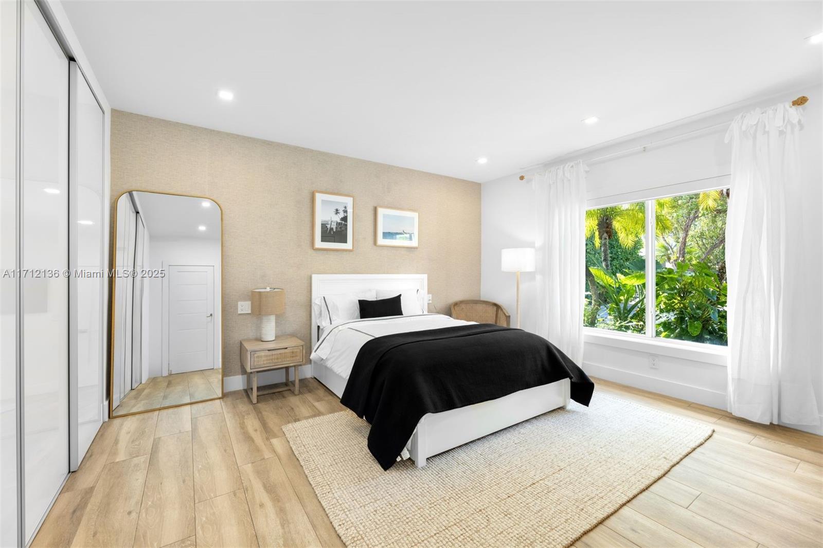 345 Gulf Road Key Biscayne, FL 33149 - Photo 24 of 43 a bedroom with a large bed and a large window