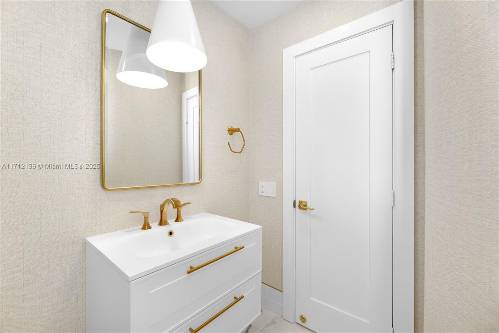 345 Gulf Road Key Biscayne, FL 33149 - Photo 25 of 43 a bathroom with a sink and a mirror