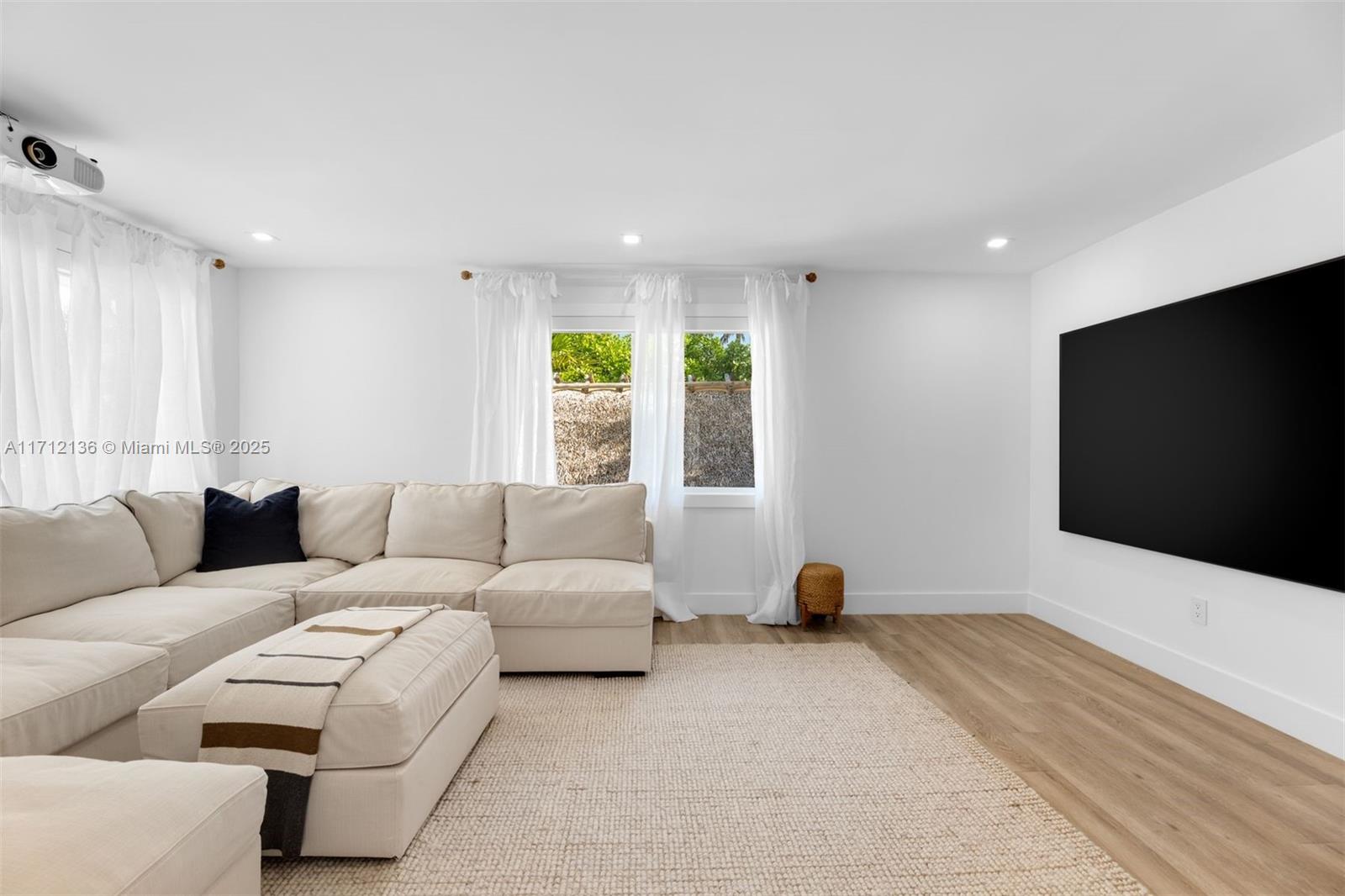 345 Gulf Road Key Biscayne, FL 33149 - Photo 28 of 43 a living room with furniture and a flat screen tv