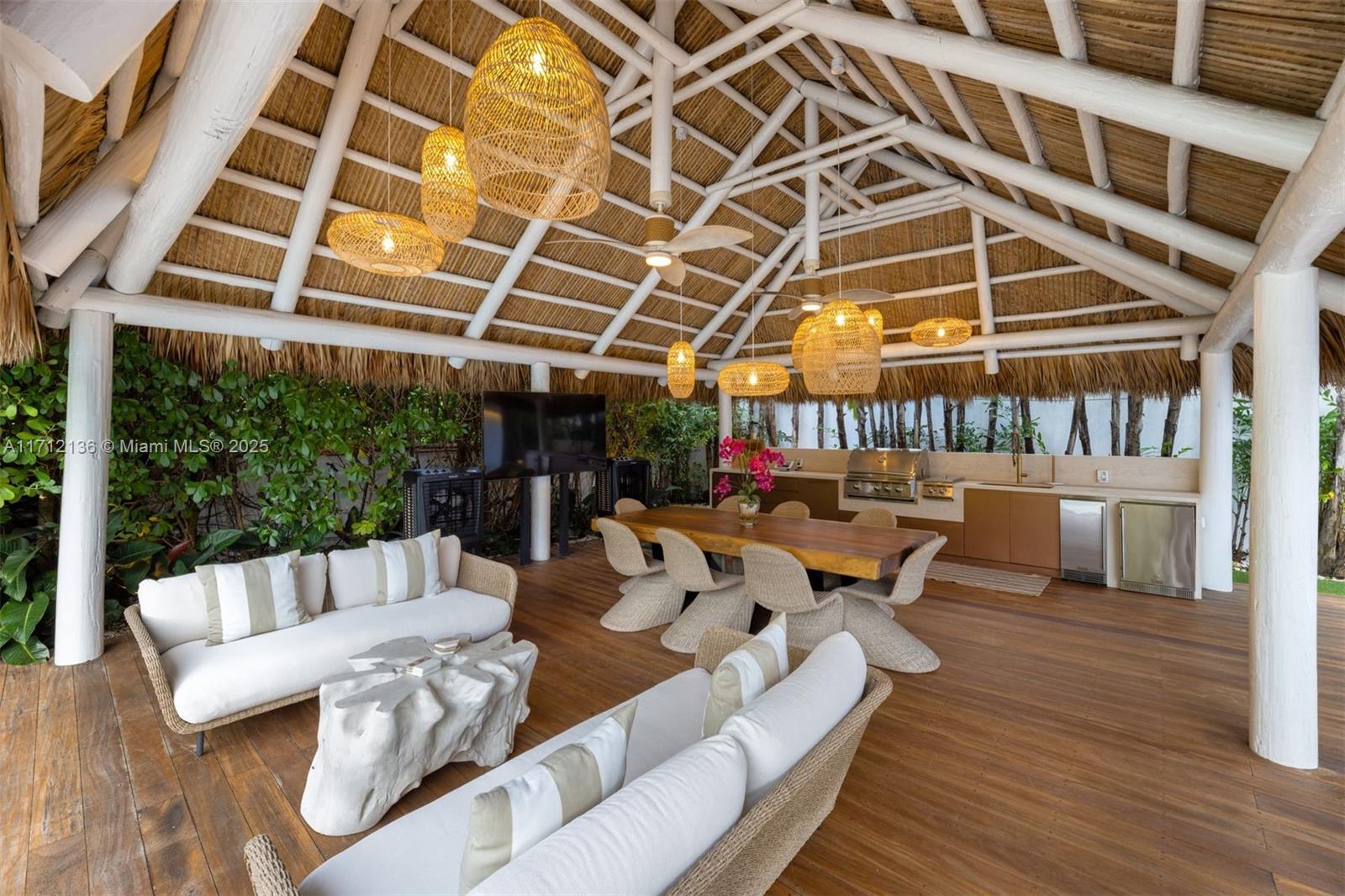 345 Gulf Road Key Biscayne, FL 33149 - Photo 32 of 43 a view of a patio with couches and a dining table and chairs with wooden floor