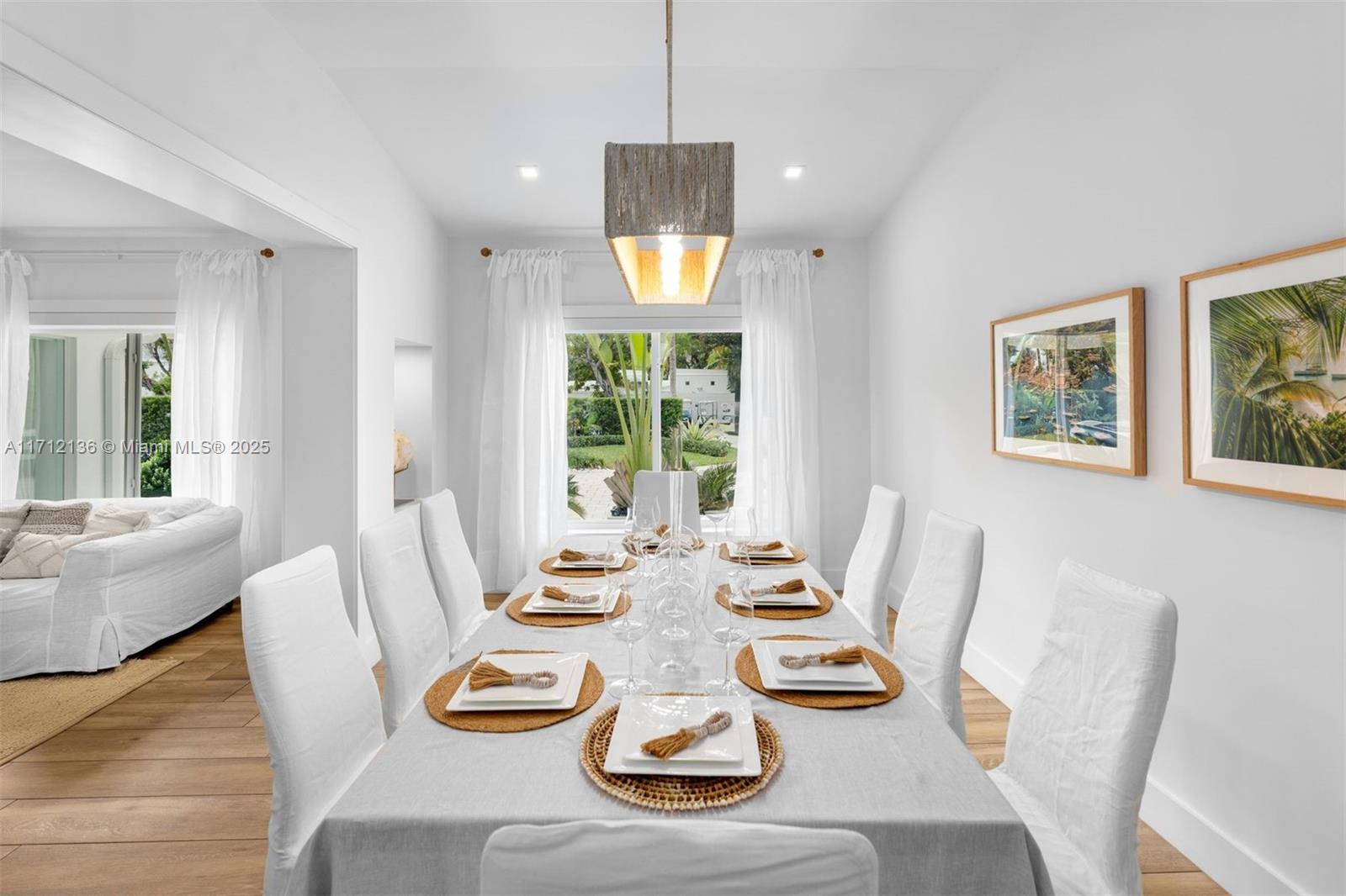 345 Gulf Road Key Biscayne, FL 33149 - Photo 6 of 43 a view of a dining room with furniture wooden floor and a chandelier