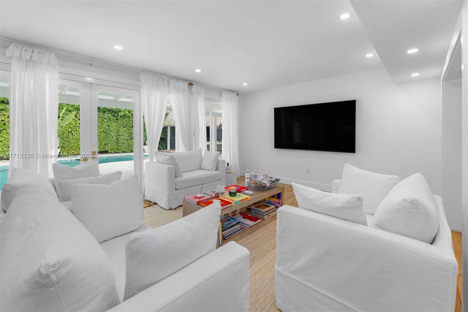 345 Gulf Road Key Biscayne, FL 33149 - Photo 9 of 43 a living room with furniture and a flat screen tv