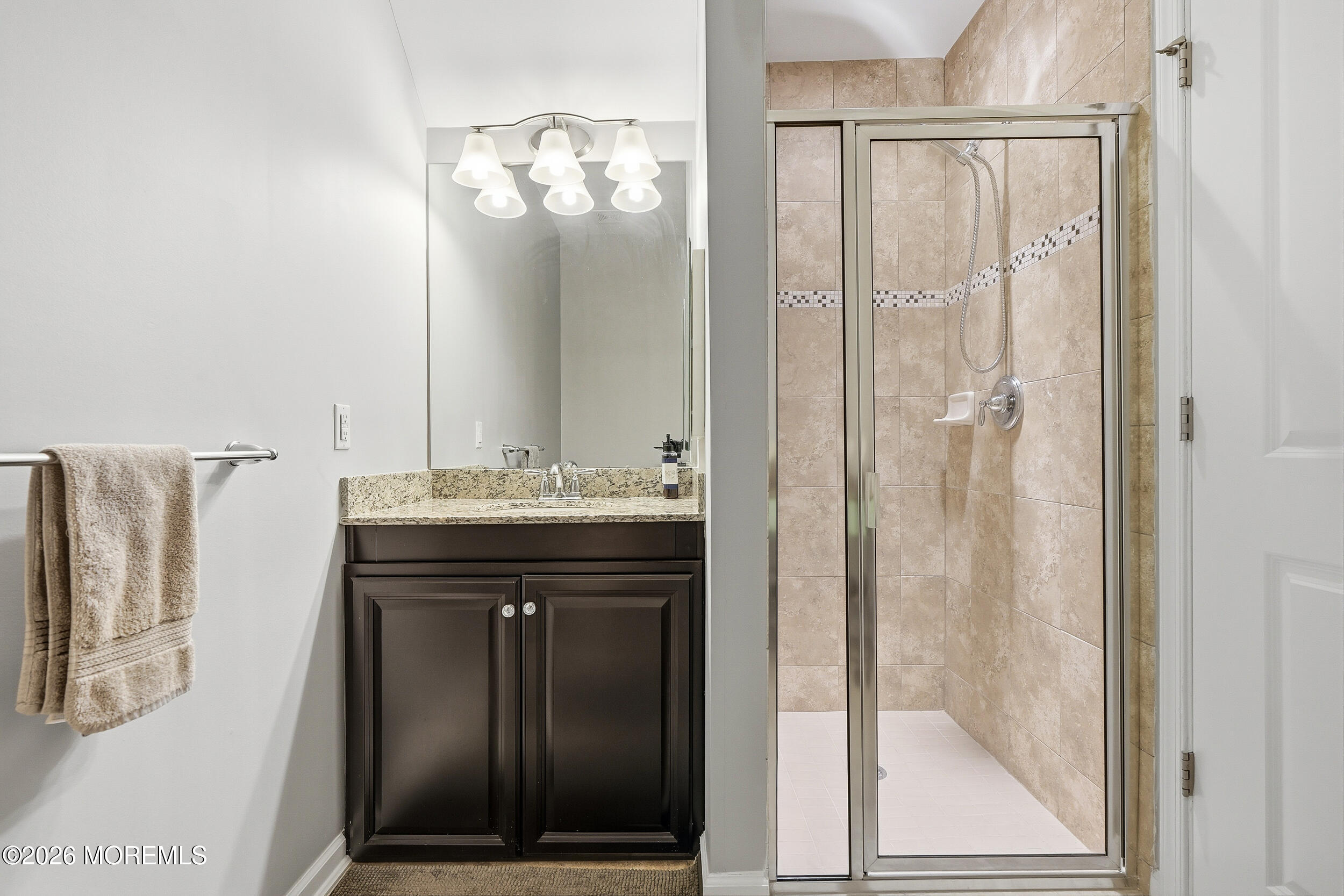 4 Kyle Drive Tinton Falls, NJ 07712 - Photo 13 of 28 a bathroom with a mirror a sink and a shower