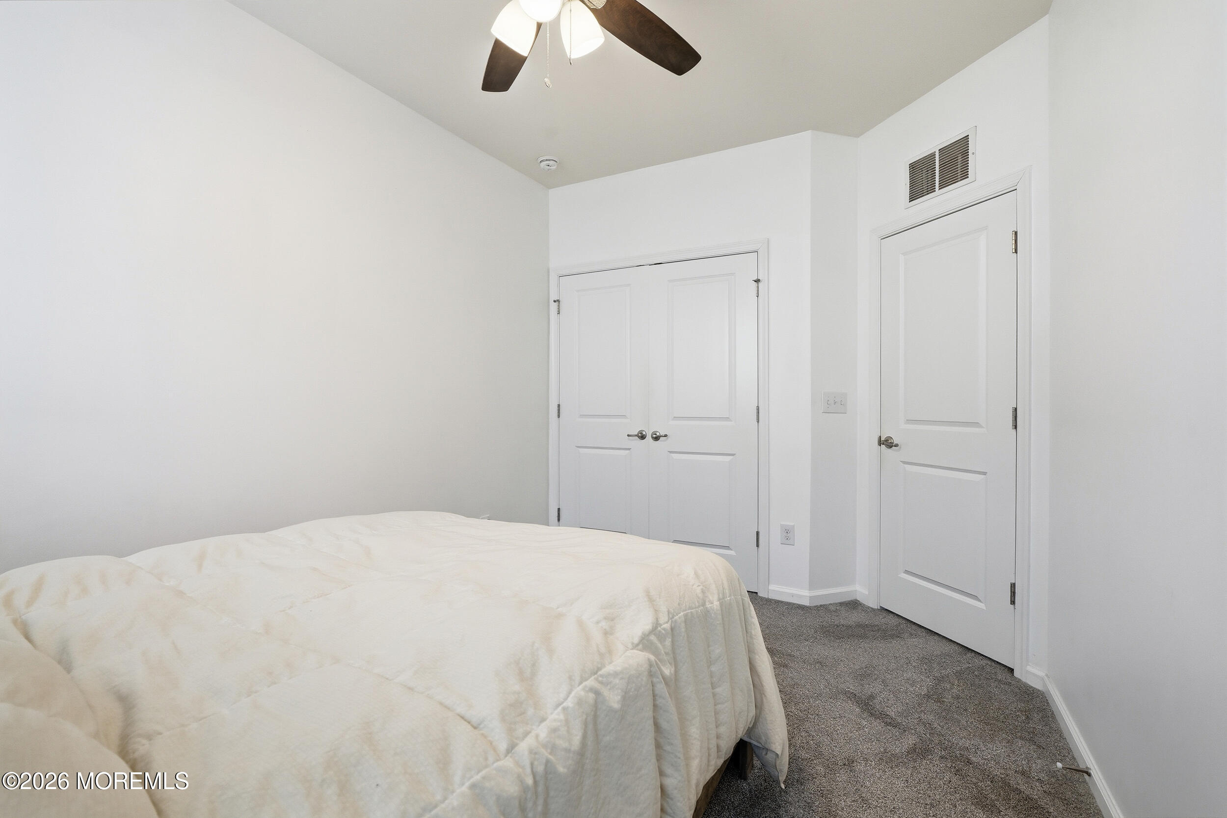 4 Kyle Drive Tinton Falls, NJ 07712 - Photo 23 of 28 a bedroom with a bed and a ceiling fan