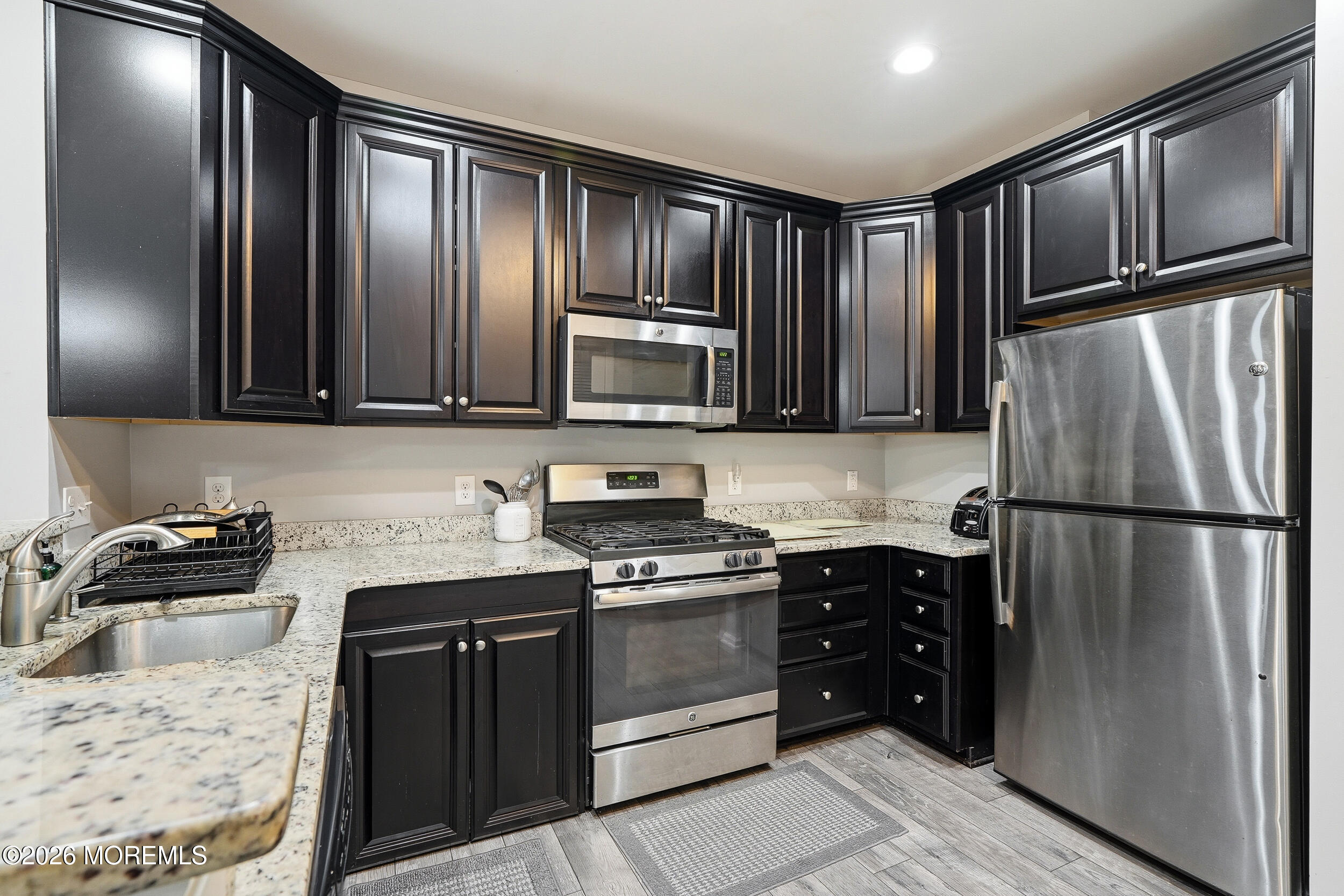 4 Kyle Drive Tinton Falls, NJ 07712 - Photo 10 of 28 a kitchen with granite countertop stainless steel appliances and refrigerator