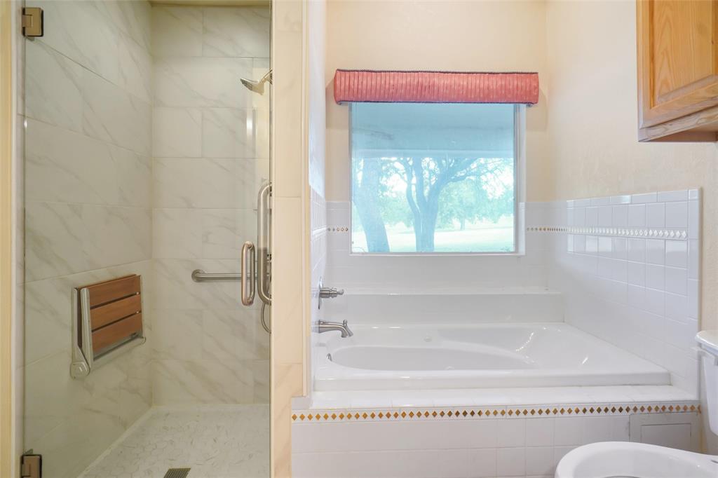 424 Half Moon Way Runaway Bay, TX 76426 - Photo 12 of 21 a bathroom with a bathtub and a shower