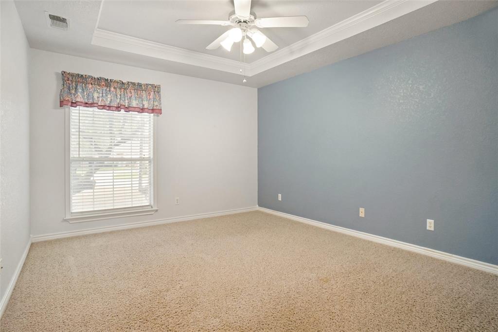 424 Half Moon Way Runaway Bay, TX 76426 - Photo 13 of 21 an empty room with a chandelier fan and windows