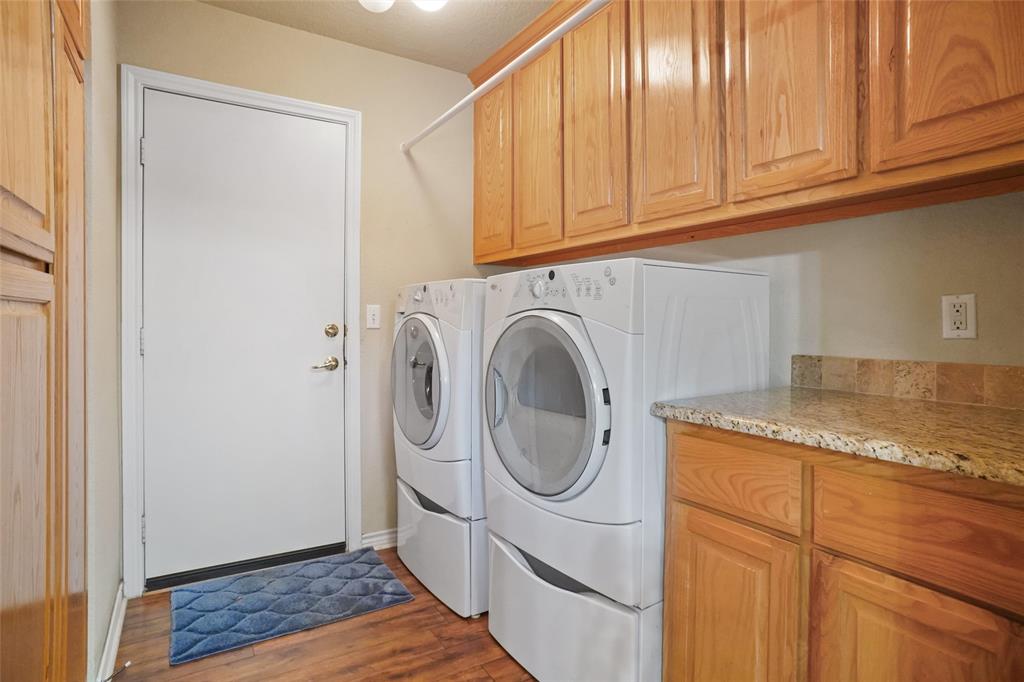 424 Half Moon Way Runaway Bay, TX 76426 - Photo 16 of 21 a utility room with granite countertop a sink a washer and dryer