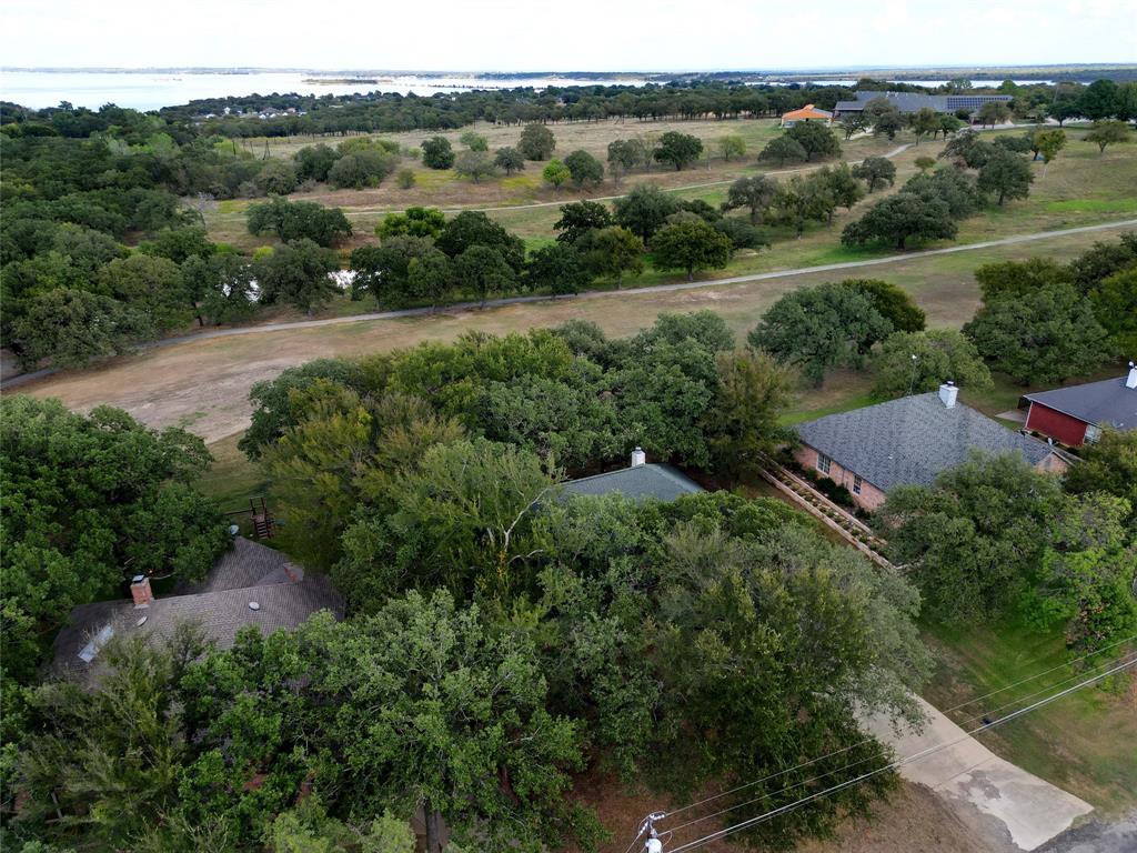 424 Half Moon Way Runaway Bay, TX 76426 - Photo 20 of 21 an aerial view of green landscape with trees houses and mountain view