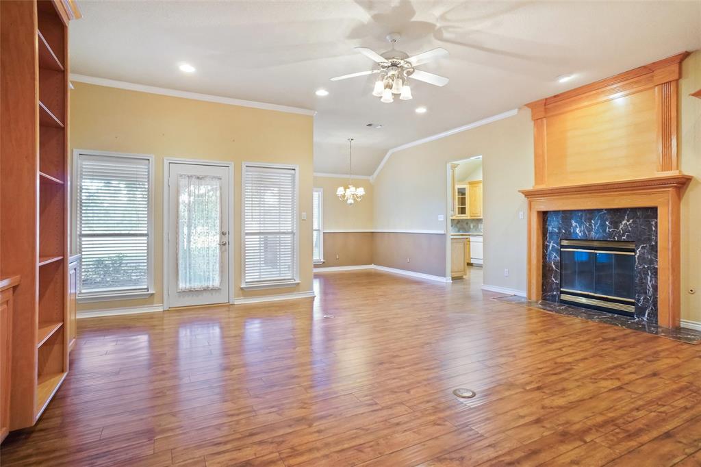 424 Half Moon Way Runaway Bay, TX 76426 - Photo 2 of 21 an empty room with wooden floor fireplace and windows