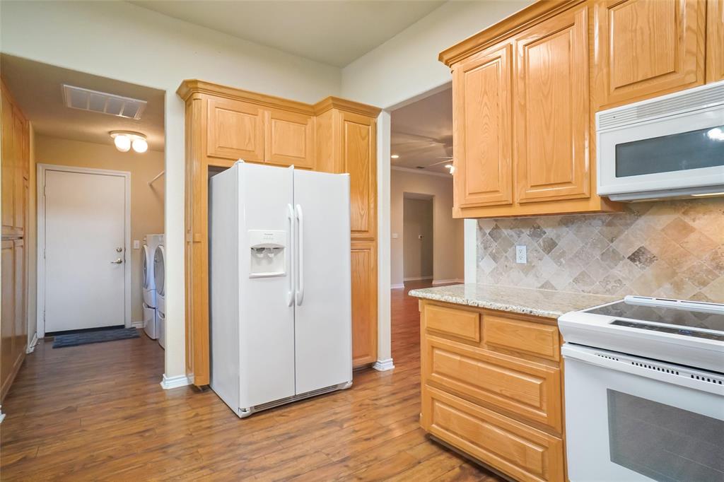 424 Half Moon Way Runaway Bay, TX 76426 - Photo 8 of 21 a kitchen with a refrigerator and a sink