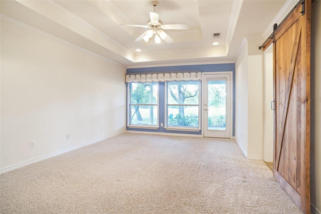 424 Half Moon Way Runaway Bay, TX 76426 - Photo 10 of 21 an empty room with windows and a ceiling fan
