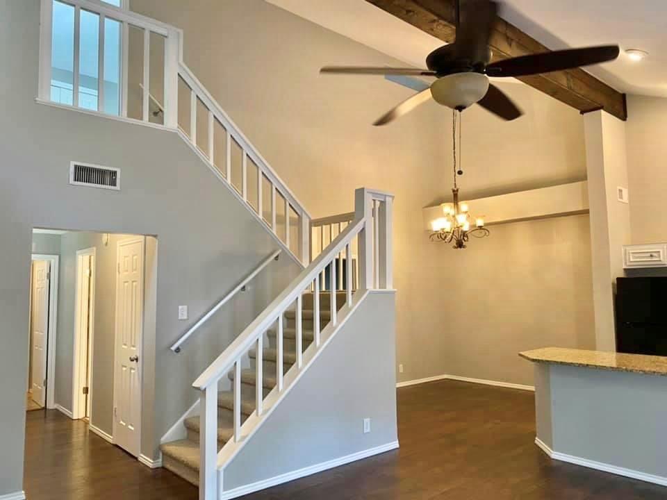 4404 Travis Country Circle, Unit G4 Austin, TX 78735 - Photo 3 of 15 An inviting interior offers a grand staircase and soaring vaulted ceilings with exposed beams.