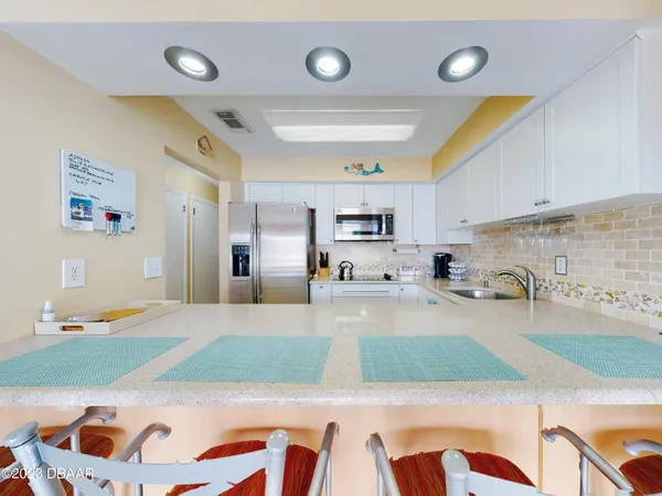 a large kitchen with lots of counter space and cabinets