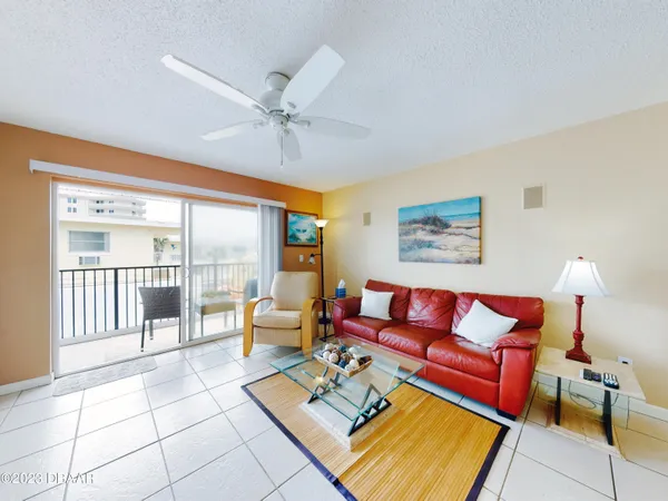 a living room with furniture and a floor to ceiling window