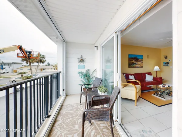a balcony with furniture and rug