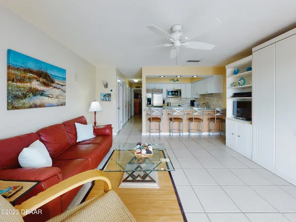 a living room with furniture kitchen view and a dining table