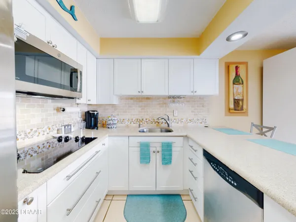 a kitchen that has a sink and a stove top oven