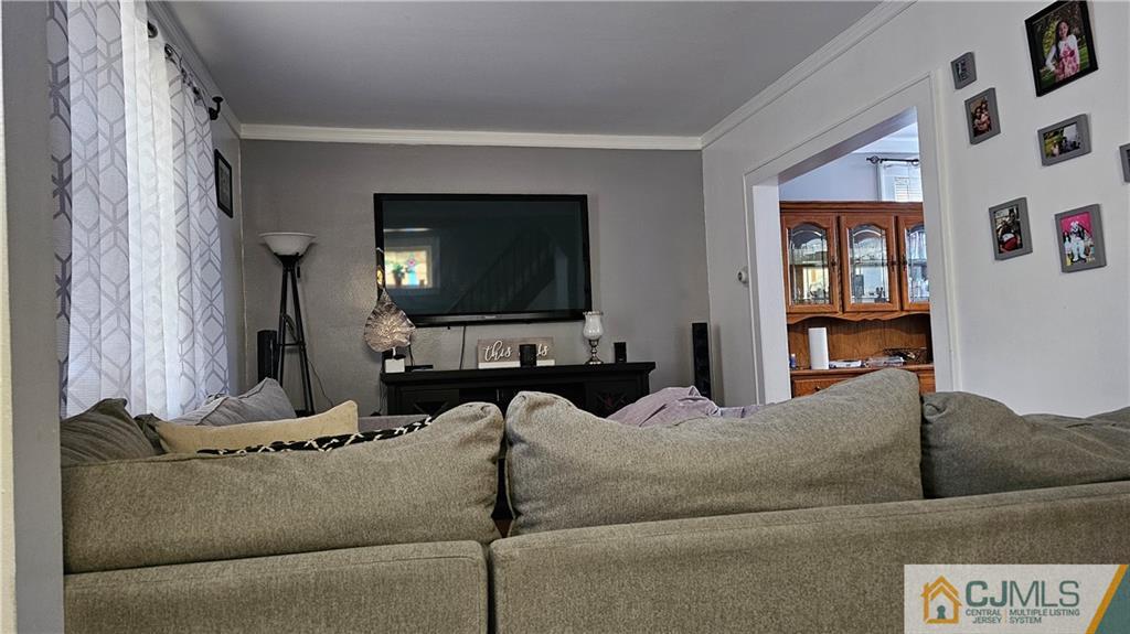 662 Jacques Street Perth Amboy, NJ 08861 - Photo 3 of 11 a living room with furniture and a flat screen tv