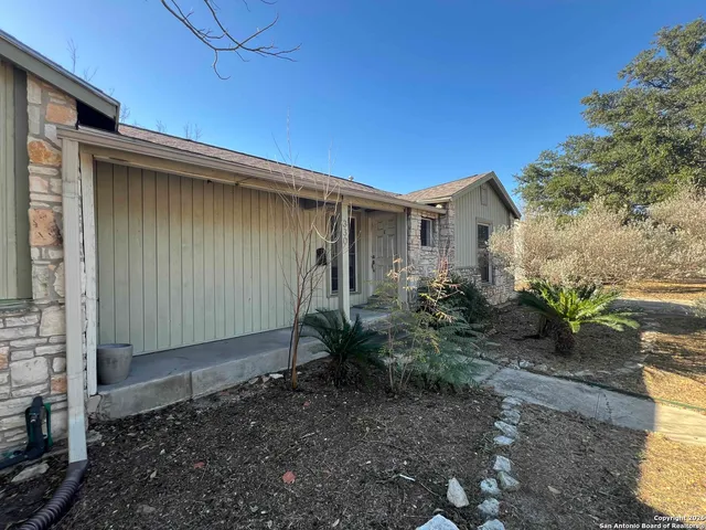 a backyard of a house with potted plants
