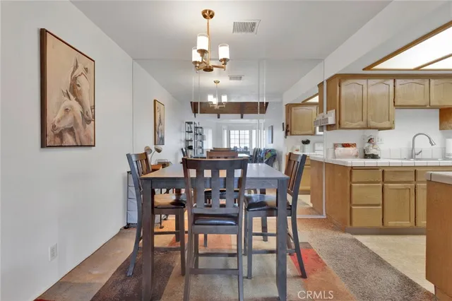 a view of a dining room with furniture and chandelier