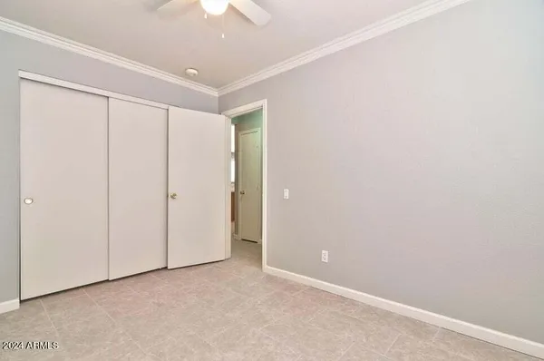 an empty room with a ceiling fan