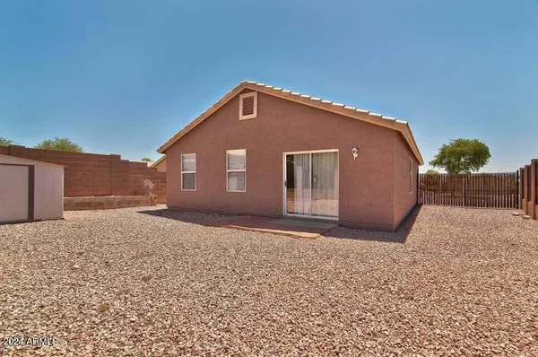 a view of a house with a backyard