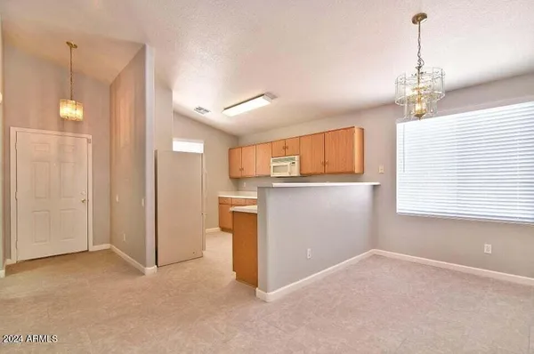 a view of a kitchen with a sink and cabinet area