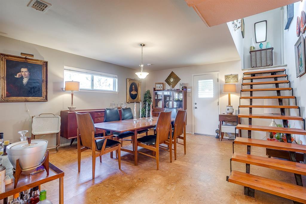 1525 Jenson Road Fort Worth, TX 76112 - Photo 20 of 40 This incredible dining roos is just off the kitchen, has a side door to the driveway and a floating staircase to the upstairs bedroom/bonus room.