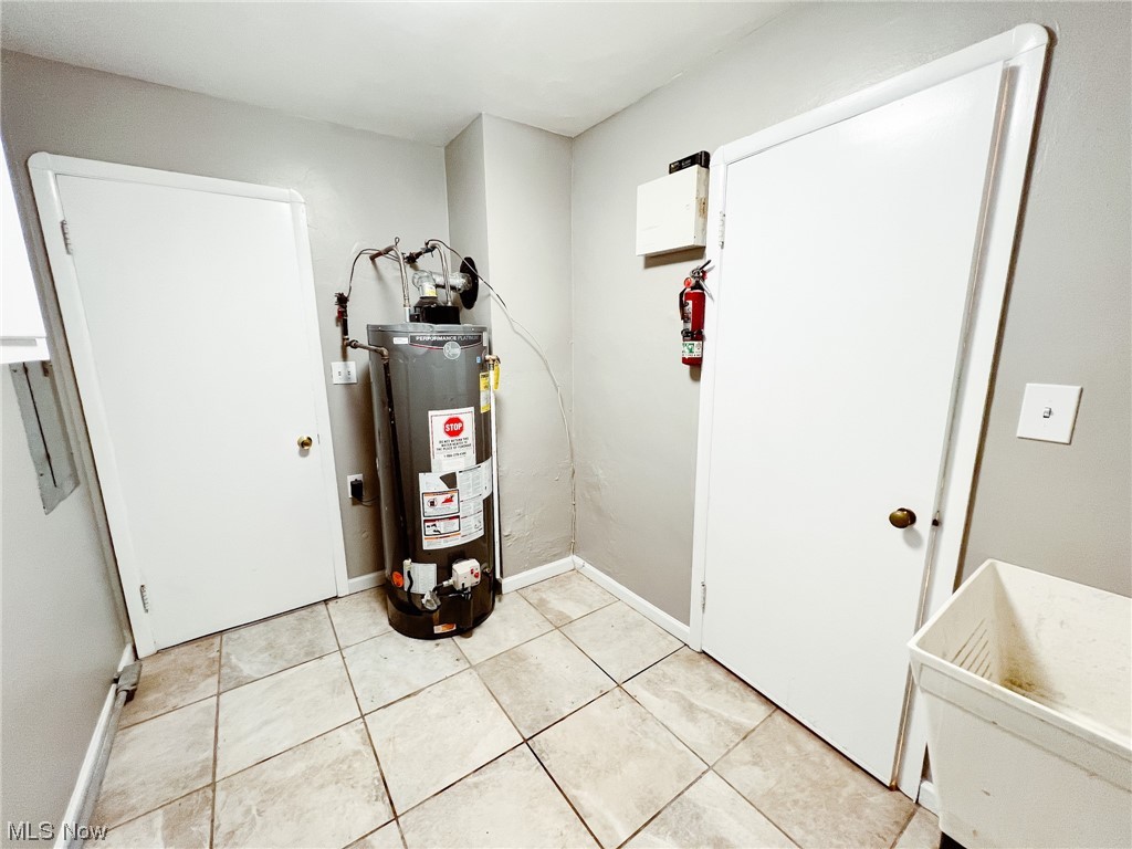 6830 Oakwood Road Parma Heights, OH 44130 - Photo 14 of 22 Utility room featuring gas water heater