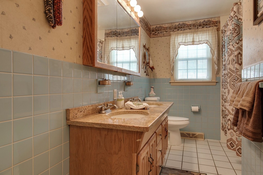 153 Leslie Road Rowley, MA 01969 - Photo 12 of 21 a bathroom with a sink a toilet and a mirror