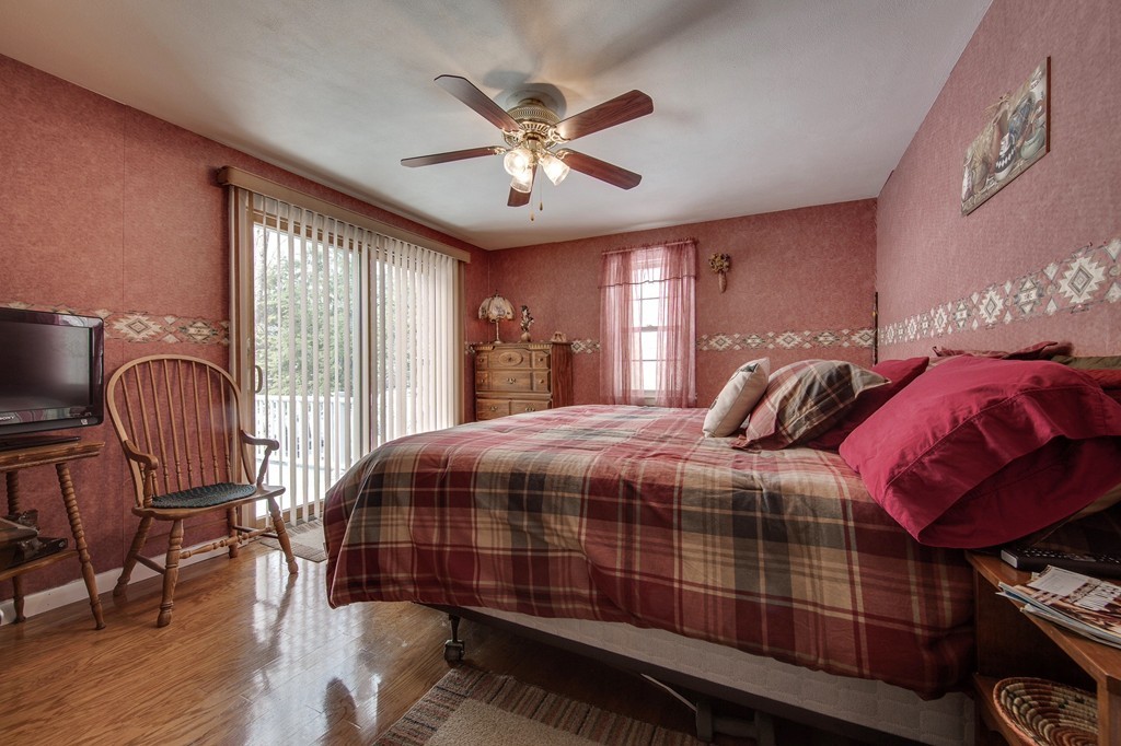 153 Leslie Road Rowley, MA 01969 - Photo 14 of 21 a bedroom with bed and wooden floor