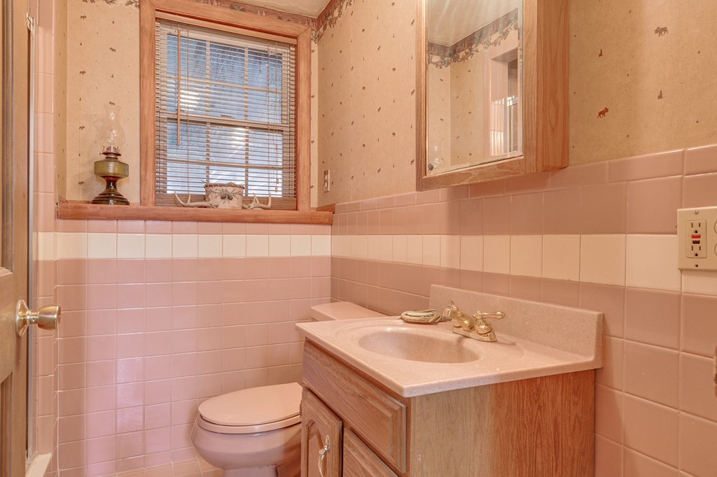 153 Leslie Road Rowley, MA 01969 - Photo 16 of 21 a bathroom with a sink a toilet and a mirror